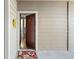 Front door opens to a beautifully decorated condo with a floral wreath and welcome mat at 7422 S Quail Cir # 1624, Littleton, CO 80127