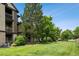 Well-manicured lawn with mature trees bordering a stylish apartment building at 7422 S Quail Cir # 1624, Littleton, CO 80127