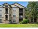 Exterior apartment building featuring balconies, well-kept lawn, and stone accents at 7422 S Quail Cir # 1624, Littleton, CO 80127