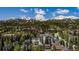 Scenic aerial shot showcasing a mountain town nestled amidst lush greenery and majestic snow-capped peaks at 200 Primrose Path # 11, Breckenridge, CO 80424