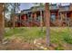 Spacious multi-story home with wood siding, stairs, and balconies surrounded by a green lawn and trees at 200 Primrose Path # 11, Breckenridge, CO 80424