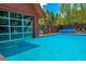 Outdoor pool with clear blue water, surrounded by lush greenery, providing a refreshing retreat at 200 Primrose Path # 11, Breckenridge, CO 80424