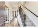 Inviting entryway with wood floors, staircase and view into the dining and living areas at 42704 Calusa Pines Rd, Elizabeth, CO 80107