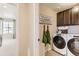 Convenient laundry room with a washer and dryer, custom cabinets, and tiled floor at 42704 Calusa Pines Rd, Elizabeth, CO 80107