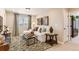 Bright living room featuring a comfortable white sofa, patterned rug, and neutral decor at 42704 Calusa Pines Rd, Elizabeth, CO 80107