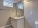 Basement bathroom featuring vinyl floor, vanity with sink, and a window at 5925 W 86Th Ave, Arvada, CO 80003