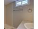 Bathroom with shower, vanity, and window providing natural light in a neutral color palette at 5925 W 86Th Ave, Arvada, CO 80003