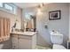 Functional bathroom featuring a vanity with a sink, a toilet, and a framed picture at 5925 W 86Th Ave, Arvada, CO 80003