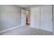 Carpeted bedroom featuring neutral walls, white trim, closet and passageway at 5925 W 86Th Ave, Arvada, CO 80003