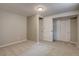 Carpeted bedroom with neutral walls, white trim and a closet with sliding doors at 5925 W 86Th Ave, Arvada, CO 80003
