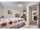 Comfortable bedroom featuring neutral walls, a patterned quilt, and a mirrored dresser at 5925 W 86Th Ave, Arvada, CO 80003