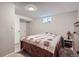 Cozy bedroom with a patterned quilt, closet, and small window for natural light at 5925 W 86Th Ave, Arvada, CO 80003