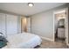 This bedroom offers a view of the en suite bathroom and features neutral tones and plush carpeting at 5925 W 86Th Ave, Arvada, CO 80003