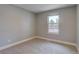 Small bedroom with neutral walls and carpet and a window looking out to the neighborhood at 5925 W 86Th Ave, Arvada, CO 80003
