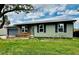 Charming single story home with a green exterior, blue shutters and brick accents at 5925 W 86Th Ave, Arvada, CO 80003