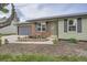 Close-up of home exterior with brick facade, well-kept garden bed, and paved driveway at 5925 W 86Th Ave, Arvada, CO 80003