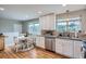 Bright eat-in kitchen featuring white cabinets, granite countertops, and stainless steel appliances at 5925 W 86Th Ave, Arvada, CO 80003