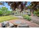 Expansive backyard boasts a patio, fire pit, lush greenery, and serene outdoor space at 5980 Dunraven Ct, Golden, CO 80403