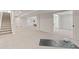 Finished basement with neutral carpeting, ample lighting, and access to additional rooms at 5980 Dunraven Ct, Golden, CO 80403