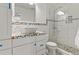 Stylish bathroom featuring colorful mosaic tile, white cabinets, and a glass-enclosed shower at 5980 Dunraven Ct, Golden, CO 80403