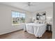 Comfortable bedroom with a ceiling fan and large window view, complemented by stylish decor at 5980 Dunraven Ct, Golden, CO 80403