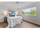 Bright bedroom with a ceiling fan, hardwood floors, and a large window providing ample natural light at 5980 Dunraven Ct, Golden, CO 80403