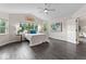 Bright bedroom with ceiling fan, hardwood floors and outside view at 5980 Dunraven Ct, Golden, CO 80403