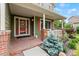 Inviting front porch with brick accents and red door creating a warm welcome at 5980 Dunraven Ct, Golden, CO 80403