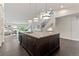 Spacious kitchen island with granite counters and three pendant lights at 5980 Dunraven Ct, Golden, CO 80403