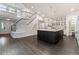 Open concept kitchen with dark wood floors and large staircase at 5980 Dunraven Ct, Golden, CO 80403