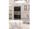 Built-in stainless steel microwave and oven adjacent to the countertop and walk-in pantry at 5980 Dunraven Ct, Golden, CO 80403
