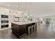 Open kitchen with a large center island, granite counters, stainless appliances and an open view to the living room at 5980 Dunraven Ct, Golden, CO 80403