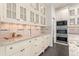 Modern kitchen with white cabinetry, granite countertops, and stainless steel appliances at 5980 Dunraven Ct, Golden, CO 80403