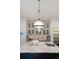 Close-up of the kitchen island featuring granite countertops, a sink, and stylish pendant lighting at 5980 Dunraven Ct, Golden, CO 80403