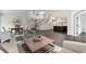 Spacious living room with hardwood floors leading to the kitchen and staircase at 5980 Dunraven Ct, Golden, CO 80403