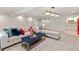 Bright living room with a sectional couch, modern lighting, and access to the kitchen at 5980 Dunraven Ct, Golden, CO 80403