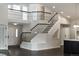 Grand foyer with a two-story staircase showcasing intricate metal railings and abundant natural light at 5980 Dunraven Ct, Golden, CO 80403