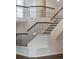 Detailed view of the staircase featuring iron railings and hardwood steps providing architectural detail at 5980 Dunraven Ct, Golden, CO 80403