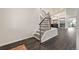Elegant staircase with decorative iron railings and wood steps leading to the upper level at 5980 Dunraven Ct, Golden, CO 80403