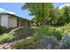 Backyard featuring lush foliage, landscaping, and a stone pathway leading to the house at 1073 Xenon St, Golden, CO 80401