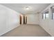 Spacious basement with paneled walls, carpet floors, and ample lighting at 1073 Xenon St, Golden, CO 80401