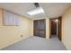 Finished basement with carpet flooring, paneled walls, a window, and a closet at 1073 Xenon St, Golden, CO 80401
