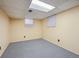 Finished basement featuring carpet flooring, paneled walls, and windows with blinds at 1073 Xenon St, Golden, CO 80401
