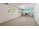 Cozy basement with brick fireplace, teal accent wall, and carpet flooring at 1073 Xenon St, Golden, CO 80401