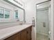 Bathroom with decorative mirror, stone countertop and a shower at 1073 Xenon St, Golden, CO 80401