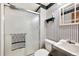 Striped bathroom showcasing a shower, a toilet, and a sink basin at 1073 Xenon St, Golden, CO 80401