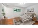 Bright bedroom featuring hardwood floors, a large window, neutral decor, and comfortable furniture at 1073 Xenon St, Golden, CO 80401