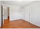Bright bedroom featuring hardwood floors and a closet with sliding doors at 1073 Xenon St, Golden, CO 80401