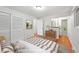 Staged bedroom showing decor, hardwood floors, and an ensuite bath at 1073 Xenon St, Golden, CO 80401