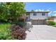 Inviting two-story home with a charming front yard, beautiful landscaping and a two-car garage at 1073 Xenon St, Golden, CO 80401